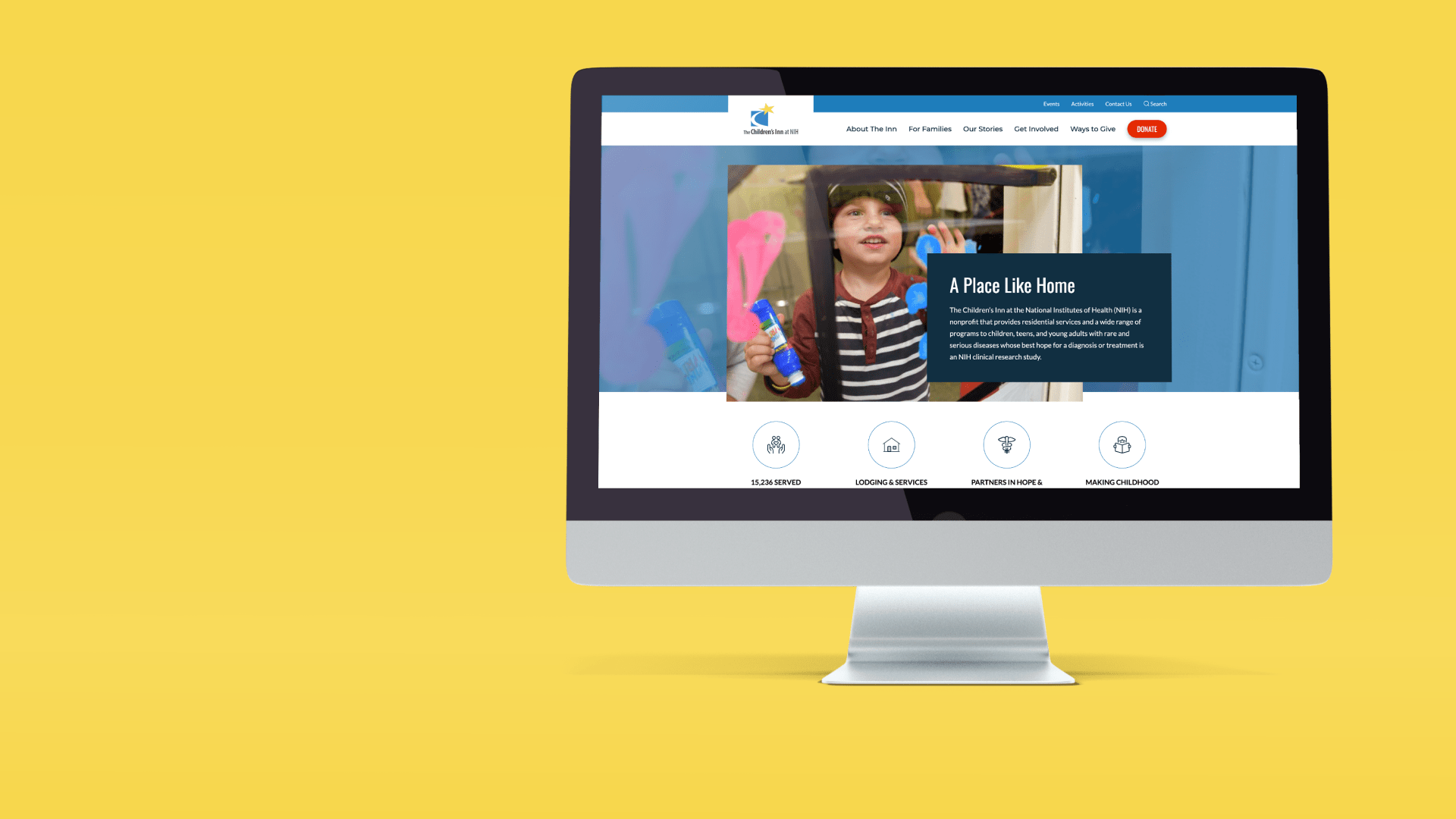 imac showing the NIH Childrens Inn homepage design on a yellow background